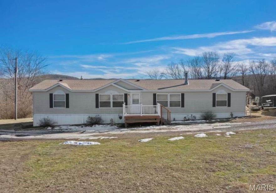 BACK ON MARKET!Charming country retreat on 10.65 acres in Elsberry, MO. Two tax parcels are being sold together. Lot 3 has lovely home that sits on 5 acres & Lot 2 is 5.65 acres (water & electric are on lot 2 as well) giving you grand total of 10.65 acres. Home offers over 1800+ sq.ft of comfortable living space. Through out you will find 3 bedrooms 2 bathrooms. Bedrooms have walk in closets, master bath has soaking tub with separate shower. Main floor laundry. Eat in kitchen with breakfast area. Separate dining that opens into living room along with great room for more seating with wood burning fire place. Enjoy the great outdoors from two decks outback that overlook a beautiful lake view, providing a gorgeous setting for relaxation and gatherings. With ample land surrounding the home there is plenty of room for outdoor activities, gardening, or even future expansions. Don’t miss out on this incredible opportunity. Schedule a showing & experience all this beautiful home and land have to offer!