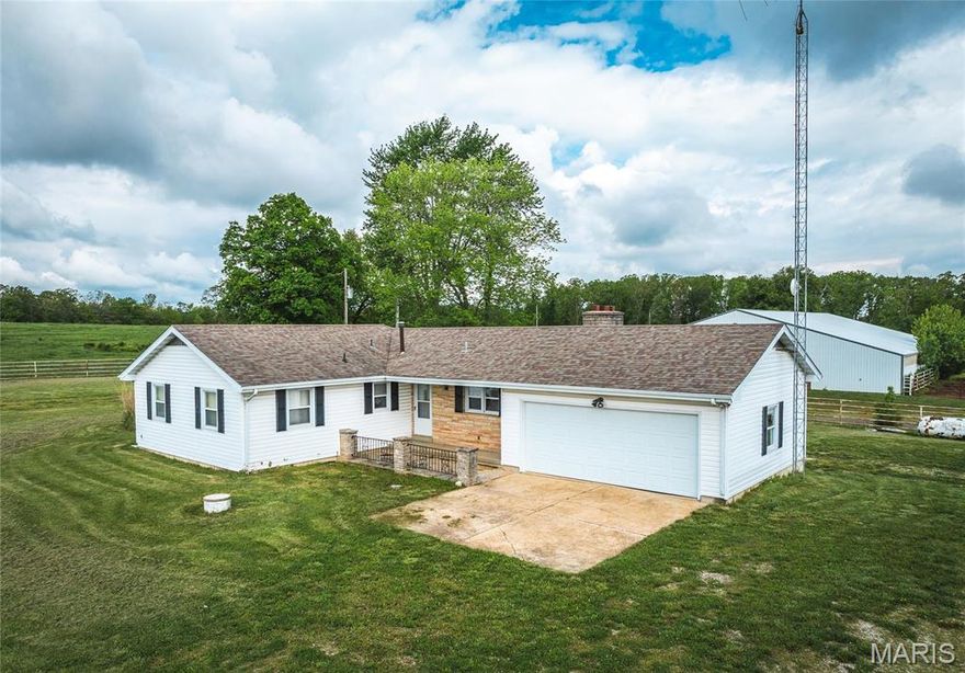 MOVE-IN READY HORSE FARM ON 20.59+/- ACRES Now Available!!  Property Features a 3 Bedroom / 1.5 Bath home, 108' x 74', 10-Stall Horse Barn/Riding Arena, and 32' x 82' Machine/Equipment Building.  The home offers an attached 2-car Garage, a spacious kitchen w/ attached dining room featuring a gas (propane) fireplace, some original hardwood floors, a full, unfinished walk-up basement, a backyard patio with fireplace, a new well in 2025, and a new furnace in 2024.  The Horse Barn features a hydrant, overhead lights & electric outlets, 4-14' x 6' stalls and 6-4' x 12' stalls, a tack/feed room, and a Pass-through door to pasture & fenced paddock.  The Machinery/Equipment Shed offers three divided areas (see floor plan in photos), two enclosed for all-weather usage with pass-through doors.  This property offers an income opportunity as a short-term rental (Airbnb) and a layover site for people travelling with horses - it has already been established for both.  BARN & ACREAGE NEXT DOOR MAY BE AVAILABLE FOR PURCHASE WITH THIS PROPERTY (see MLS # 25067779)