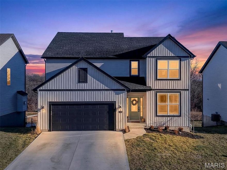 Better than new and just one year old, this stunning two-story home in Wentzville offers the perfect blend of modern design and everyday comfort. Step inside to tall ceilings, LVP floors, and an open floor plan designed for both entertaining and daily living. The kitchen is a true centerpiece, featuring Quartz countertops, a center island with breakfast bar, stainless steel appliances, and a 5-burner gas range. It flows seamlessly into the breakfast room and spacious great room, where a cozy gas fireplace creates an inviting atmosphere. The breakfast room opens to a composite deck through a glass slider, extending your living space outdoors.
The main level also includes a dining room, powder room, and a flexible bonus space ideal for a home office or playroom. Upstairs, you’ll find all four bedrooms—each with walk-in closets—along with a versatile loft and a convenient upper-level laundry room. The primary suite offers a private retreat with beautiful tray ceiling with an ensuite bath. The unfinished walkout lower level provides endless potential and opens to a patio overlooking the fully fenced backyard that backs to trees for added privacy. An oversized garage with a 14’ extension bump offers extra storage and workspace. Located in the highly sought-after Wentzville School District and just minutes from Highway 70, shopping, dining, and everyday conveniences—this home truly has it all.