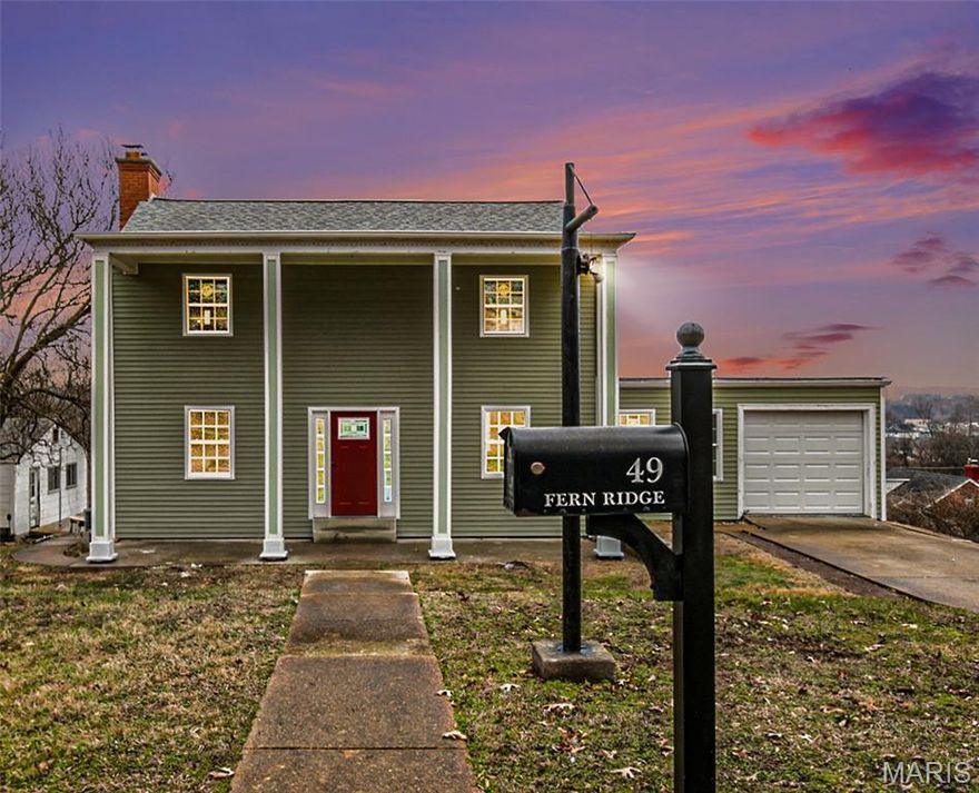 Enjoy the curb appeal as you walk up to a large 2 story covered porch with columns. Step inside to beautiful wood floors flowing throughout the main level. The spacious great room welcomes you with a ceiling fan, coffered ceilings, wainscotting, and open layout, while the dining area connects seamlessly to a country kitchen featuring sage-colored cabinetry, butcher block countertops, a white subway tile backsplash, and stainless steel appliances. A sliding barn door opens to a private office with ceramic tile flooring and a nearby full bath. Off the kitchen, a bright breakfast room offers a cozy space to start your day and opens to a deck overlooking the trees—perfect for relaxing or entertaining. Upstairs, wood floors continue through all bedrooms, each with ceiling fans, along with a full tiled bath and a comfortable primary suite. Attached one-car garage adds convenience. Don't miss this great opportunity in Valley Park!