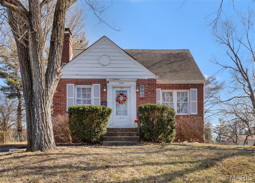 As you enter, you’re welcomed into a warm and inviting living room highlighted by original millwork, rich hardwood floors, and a classic wood-burning fireplace that serves as the heart of the home. Natural light pours through the windows, enhancing the timeless charm and character that make this bungalow truly special.

Flowing seamlessly from the living room, the dining area offers an ideal space for gathering and entertaining, with beautiful wood tones and an easy, natural layout that connects the main living spaces.

The primary bedroom provides a peaceful retreat and features private access to the enclosed rear patio — a versatile, light-filled space perfect for a home office, creative studio, or quiet morning coffee nook. The full bathroom showcases vintage character and classic details that complement the home’s historic appeal. A comfortable second bedroom rounds out the sleeping quarters, offering flexibility for guests, family, or additional workspace.

The kitchen maintains its charm while offering functional space and direct access to the covered patio, creating a wonderful extension of the main level for outdoor dining or relaxing. This connection between indoor and outdoor living completes the main floor layout beautifully.

Upstairs, the expansive unfinished attic presents incredible potential. With its impressive size and character, it could be transformed into additional living space, a primary suite, studio, or bonus room. As it stands, it has served as a spacious office setup and offers abundant storage.

The walk-out basement features high ceilings and provides substantial opportunity for finishing or workshop space. With exterior access, it adds flexibility and functionality rarely found at this price point.

Situated on a generous .51-acre lot, the property offers plenty of room for entertaining, gardening, or simply enjoying the outdoors. The driveway accommodates up to four vehicles, and a detached one-car garage provides additional storage or parking convenience.

Brimming with warmth and historic character, this charming home is being sold as-is and offers a rare opportunity to reimagine, restore, and create lasting value while honoring its timeless appeal.