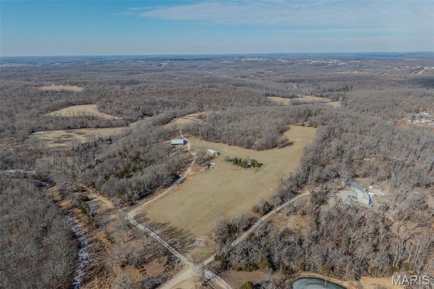 This expansive 233.45-acre property offers a unique combination of natural beauty, versatility, and privacy, making it perfect for a variety of uses. This property boasts a wealth of key features, including two wells, two natural springs, and two ponds, providing ample water for farming or livestock. A spacious 40x60 concrete-floor barn with lean-tos on each side offers great storage or livestock shelter, while a small shop provides additional workspace. The property is fully equipped with roads throughout, ensuring easy access to every corner, and is situated privately at the end of the road. It is also surveyed for subdivision, offering potential for future development. Whether you're looking to expand your agricultural operation, create a private retreat, or develop a subdivision, this property offers endless possibilities. With its mix of natural features and practical infrastructure, it’s an ideal spot for both work and recreation. Don't miss this rare opportunity to own a versatile, private, and accessible property just minutes from town. Call today to schedule a showing!