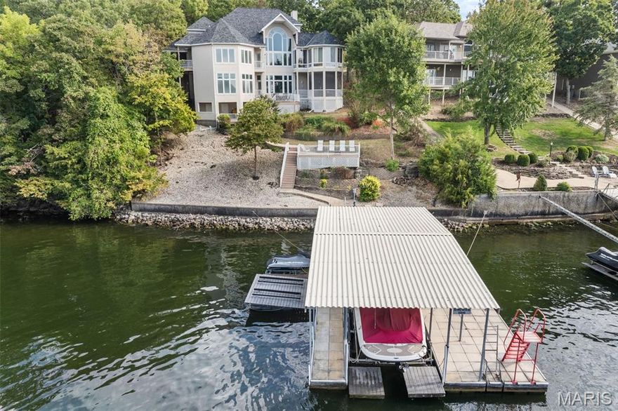 It’s All About the View! Prepare to be captivated the moment you step into this Majestic 5-bedroom, 4.5-bath, 5,700+ sq. ft. lakefront home on MM10 in the sought-after Four Seasons community w/all the well-known amenities! Nestled in a small inlet just off the main channel w/breathtaking views, this well-cared-for residence is designed for entertaining, relaxing, & creating unforgettable memories of the lake. Highlights: Main-level living w/ spacious primary suite, eat-in kitchen, formal dining area & laundry; Upper-level primary suite w/ balcony overlooking the living room; Lower-level retreat featuring 4 bedrooms (2 w/ensuites, 1 non-conforming), a full bar/kitchen, pool table, & gathering space. Multiple sun-filled living areas include a sunroom perfect for relaxing. Room for a future elevator in both living areas. Enjoy 4 lakeside decks/patios, hot tub, & large patio perfect for entertaining. The dock features a 12x30 slip w/hoist, 3 PWC slips w/lifts, & swim platform. With 4 primary suites, 2 gas fireplaces, & abundant storage, this property is truly one-of-a-kind. This gem offers the perfect blend of space, comfort, & iconic Lake of the Ozarks living.