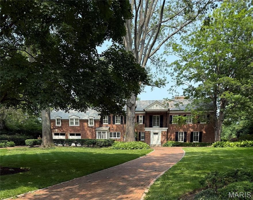 Tucked away in a secluded park-like setting in the heart of Ladue, this gracious two-story home has been impeccably maintained & thoughtfully updated. The layout flows seamlessly from the elegant living room to the expansive paneled family room & stunning curved garden room, which opens to a sprawling patio. A charming, updated kitchen & spacious dining room provide the perfect backdrop for entertaining.Upstairs, the primary suite boasts a dressing area, generous closets & an en-suite bath. 5 additional bedrooms & 4 updated bathrooms complete the 2nd floor, with 2 currently used as offices. The lower level features a recreation room for added space. The approx. 24x24 garden room, with its curved exterior wall, offers panoramic views of the lush grounds. Ample storage & front & back staircases enhance convenience. Major updates include an elevator, newer roof, upgraded electrical & a significant 1986 expansion. The beautifully landscaped 2.48-acre lot offers remarkable privacy.