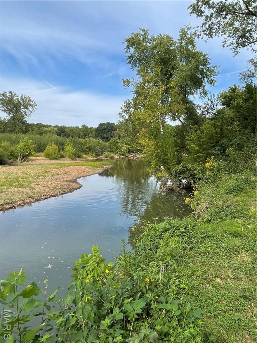 Scenic Homesite on Nearly 11 Acres with River Frontage – A Rare Natural Haven Close to Town Welcome to your own private sanctuary
nestled on nearly 11 pristine acres, where the beauty of nature meets the convenience of town living. This exceptional homesite boasts
approximately 600 feet of Big River frontage, complemented by additional frontage along the serene Flat River Creek, offering an idyllic
setting for your dream home, retreat, or recreational getaway. Key Features: Expansive 10.87± Acre Parcel: Gently rolling terrain,
mature trees, and open clearings provide the perfect mix of buildable space and natural beauty. 600 Feet of Big River Frontage: Enjoy
direct access to one of the area's most scenic waterways—perfect for kayaking, fishing, or simply relaxing by the water’s edge. Flat River
Creek Frontage: Adds an additional tranquil water element, enhancing the biodiversity and peaceful ambiance of the property. Abundant
Wildlife: A haven for deer, turkey, birds, and other native wildlife. Ideal for nature lovers, photographers, or hunters seeking a private
piece of paradise. Utilities Nearby: Electricity currently on property as well as city sewer and a well, making development straightforward
while preserving the rural charm. Minutes from Town: Enjoy the peace and privacy of a secluded setting without sacrificing access to
local amenities, schools, shopping and Highway 67 - just minutes away. Whether you're looking to build your forever home, establish a
weekend escape, or invest in a unique piece of land with incredible natural features, this property offers unmatched potential. Don't miss
this rare opportunity to own a slice of riverside tranquility—where the sights and sounds of nature greet you every day, and town is just
down the road.