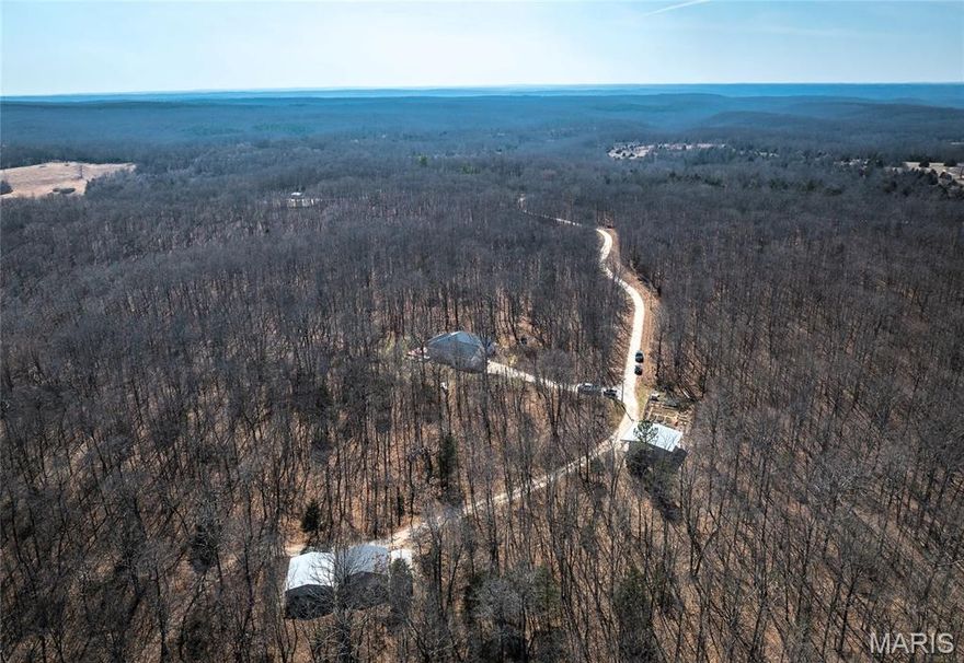 Nestled in the heart of the Ozarks with one mile bordered by the scenic Mark Twain National Forest, this exceptional 166 (+/-) acre property offers the perfect blend of comfort, privacy, and outdoor recreation. The land is fully fenced and thoughtfully maintained. Featuring four established food plots, a maintained firebreak system, ATV trails, and four ponds! The large pond is an acre, stocked, and has a one room cabin that overlooks it. The custom built home features 2-3 bedrooms and 2 full bathrooms. The kitchen boasts beautiful custom maple cabinets and stainless steel appliances. Energy efficient 6 ft tall windows opening into the sunroom offer tons of natural light and views of the abundant wildlife and stunning views. This home also has a large multilevel back deck with a hot tub making it perfect for entertaining or just enjoying nature. The garden is fenced with 6 ft chain link fence and has established blueberry and asparagus beds. Two outbuildings that are ideal for a workshop and storing your equipment. Newer roof, siding, HVAC, 16 KW emergency propane generator, FEMA design storm room, plus so much more! All this conveniently located less than 5 miles from I-44 with easy access to Fort Leonard Wood and only 3.5 miles from a blue ribbon trout stream. Big and Little Piney river are close by along with lots of other floating and fishing parks. This remarkable property is truly one you have to see to believe! Call to schedule a showing today.