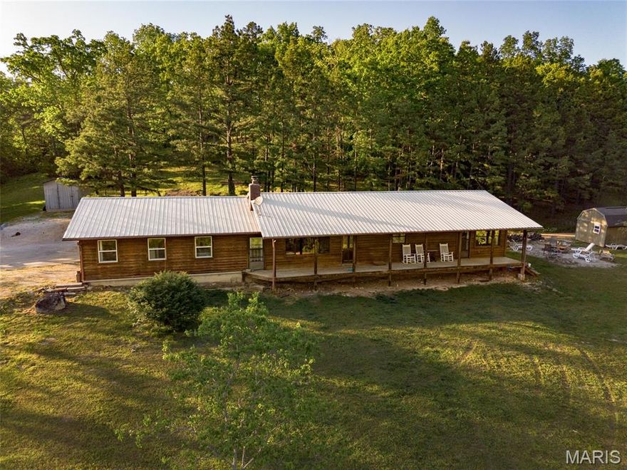 Welcome to the country, where quiet mornings and wide-open skies set the tone for everyday living. This charming 3-bedroom, 1-bath cedar-sided home rests on 6.78 picturesque acres, surrounded by gently rolling land and the soothing sounds of nature. Located just minutes from Bunker, it offers the perfect balance—close enough for convenience, yet far enough to feel like your own private retreat. Start your day on the expansive front porch, coffee in hand, as deer wander gracefully through the yard and wild turkeys pass by in the distance. Inside, the home welcomes you with an open floor plan that creates a warm, inviting flow between the spacious living room and kitchen—ideal for gatherings, laughter, and making memories. On crisp autumn evenings, the large wood-burning fireplace becomes the heart of the home, filling the space with a cozy glow and the comforting crackle of burning logs. The three bedrooms provide flexibility for family, guests, or a home office, while the oversized master bedroom stands out with its generous proportions and potential to add a private ensuite bath tailored to your vision. The bathroom offers ample space and storage, blending practicality with comfort. Every corner of this home reflects a slower, more peaceful pace of life—where nature, space, and simplicity come together beautifully.