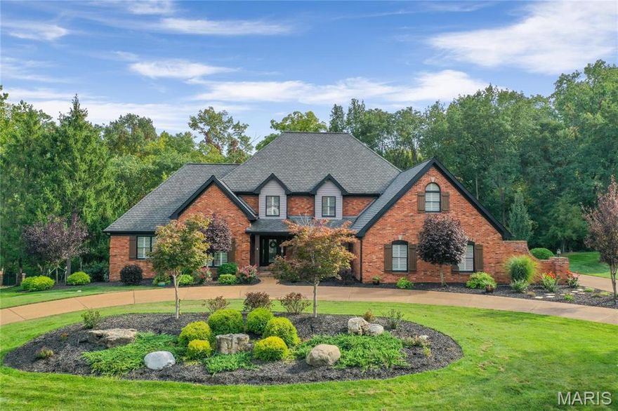 Exquisite 1.5-story residence nestled on a meticulously landscaped 1-acre lot with sweeping views of Queeny Park. Designed for both entertaining and everyday living, this home showcases exceptional outdoor amenities, including dual patios, a custom fire pit,a professional grilling station, fenced grounds, and a private sports court. Inside, hand-finished wood floors and refined millwork set a sophisticated tone. The ML offers a formal dining rm, a vaulted office with bespoke bookcases, and a striking great rm with beamed ceilings, a dual gas/wood-burning fireplace, and seamless access to the vaulted sunrm. The gourmet kitchen is a true centerpiece, appointed with quartz countertops, a waterfall island with gas cooktop, double ovens, wine refrigerator, ice maker, an adjoining breakfast rm, and a custom see-through bar connecting to the great rm. The primary suite is a serene retreat with a spa-inspired bath offering dual vanities, soaking tub, custom walk-in shower, and a tailored closet. Upstairs, discover three spacious bedrms, a full bath, Jack & Jill bath, and a loft with built-ins — ideal for a reading nook, lounge, or study space. The walkout LL extends the living space with a family rm and fireplace, wet bar, rec/game rms, exercise studio, bedrm, and full bath. Additional highlights include a finished 3-car garage with 220v service for EVs, solar panels, and countless thoughtful upgrades. A rare opportunity to own a luxurious retreat in the heart of Town & Country.