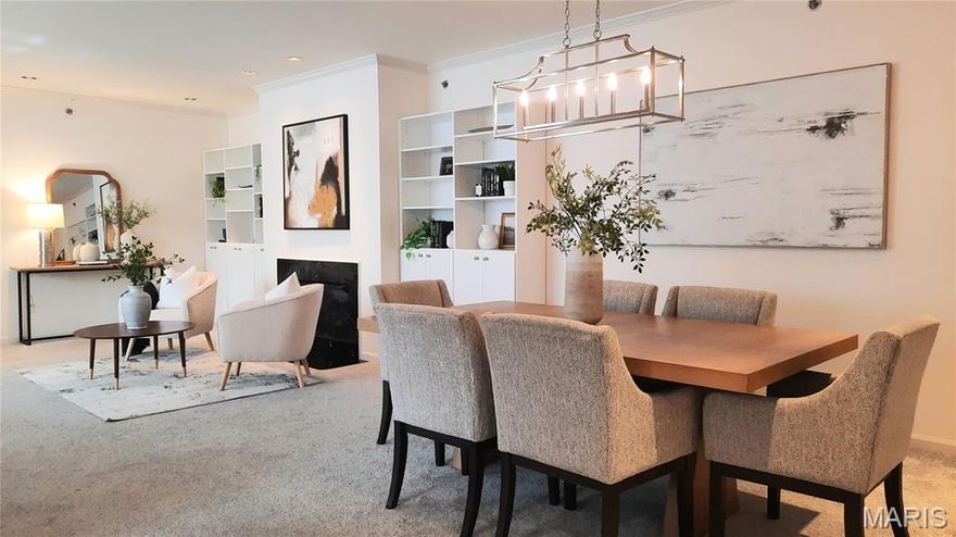 This lovely, spacious end unit with an open floor plan truly has it All.  Abundant natural light fills the inviting living room, highlighted by a handsome marble fireplace - perfect for cozy evenings at home. Elegant crown molding accents the living and dining room areas, adding timeless charm. Entertain with ease in the graciously sized dining room, which offers seamless access to the beautifully updated kitchen - designed for today's discerning buyer.  The kitchen features gorgeous granite countertops, a center island, pantry, and brand-new stainless steel appliances including refrigerator, dishwasher, stove, and microwave.  French doors from the eat-in-kitchen lead to an expansive covered balcony. Enjoy relaxing on the delightful, covered balcony nestled among the treetops, offering privacy and the perfect setting for morning coffee, evening dinners, or simply unwinding! Convenient main-floor laundry includes washer and dryer.  The generous primary suite features a well-organized walk-in-closet and a private bath complete with a large soaking tub, separate shower, and double vanity.  The second bedroom (or use as an office) offers direct access to the covered balcony.  Kitchen improvements include new LVP flooring, light fixture, appliances, granite counter tops, new blinds and painted kitchen cabinets.  Newer LVP in foyer and carpet though out. Entire unit was freshly painted in 2026. New light fixture in dining room. Recently refurbished balcony. Newer keyless lock on front door. A small pet permitted. Great location that is walkable to downtown Clayton and close to restaurants. There are two assigned garage parking spots with two garage door openers and a storage shed.  Secure building with elevator. You won't be disappointed...it's just what you've been waiting for!!