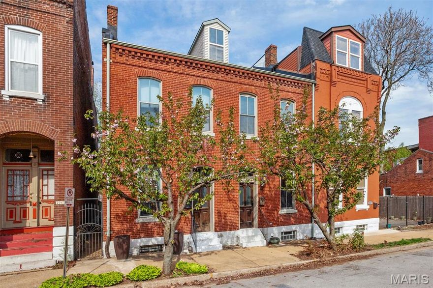 Come walk this oh-so-stylish 3 bedroom, 2.5 bath property with deluxe kitchen tucked right into the beating heart of the beautiful Benton Park neighborhood. Carefully maintained and tastefully updated since a gut renovation roughly 20 years ago, this historic townhome combines urban, contemporary style with the flavor of one the most architectural significant neighborhoods in STL. On the front stoop, step past the charming gas lantern and through the original arched window doorway into a handsome living room sporting high ceilings, lovely millwork, original heart-of-pine flooring and an ornate gas fireplace. The generous dining room is right off an eat-in chef's kitchen replete with storage, high-end stainless appliances (including a wine fridge), and granite countertops which are truly spacious enough for too many cooks. On floor 2 you'll find 2 beautifully outfitted bedrooms that both offer generous space, natural light and privacy. The primary suite sports lofted ceilings with skylight and an en-suite bath with a dual vanity and generous shower, as well as a gracious walk-in closet. An additional hall bath w/combined tub and shower guarantees plenty of elbow room in the a.m. The top level opens to a loft bedroom/play/work space with skylights and plenty of area to lay out the big projects. Out back discover a truly private courtyard with outdoor wood-burning fireplace for cool evening gatherings, and an enclosed single car garage. You'll appreciate the parking because this is an area made to explore on foot; stroll down to Blues City Deli for lunch, Venice Cafe for music, or cross the bridge into Soulard for the party. Did I mention that nearly all the tasteful contents are available for negotiation out of contract? All that's left for you to do is pack a suitcase and move in!