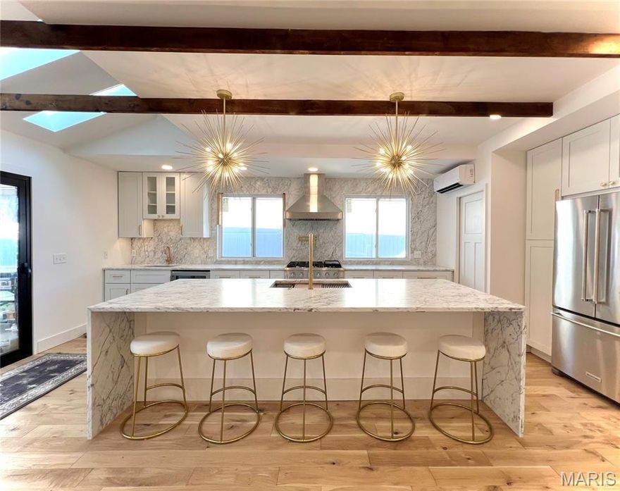 Agent owned.  Francis Howell Central High School, unincorporated Saint Charles County.  Designer kitchen with waterfall island, real ITALIAN marble backsplash, 6 burner gas cooktop, KITCHENAID wall oven/microwave, drink fridge, pantry cabinets, laundry built in.  Outdoor kitchen with built in flat top, sink, and room for additional grill and pizza oven; natural gas so no need to replace the propane ever. 888 sq-ft surface area Saltwater pool with Baha tanning ledge (doubles as kiddie pool and has bubbler), 4 deck jets, sports court designed, HEATED, cartridge filter, travertine coping & patio, surrounded by turf.  The lot is huge with a creek contained on the property and adjacent to a large 40+ acres of continuous common ground area in the neighboring subdivision.  Basement has a kitchenette, full bath, recreation area with wood fireplace, and a room with closet, electric fireplace, and additional laundry. Large, detached garage or workshop area.