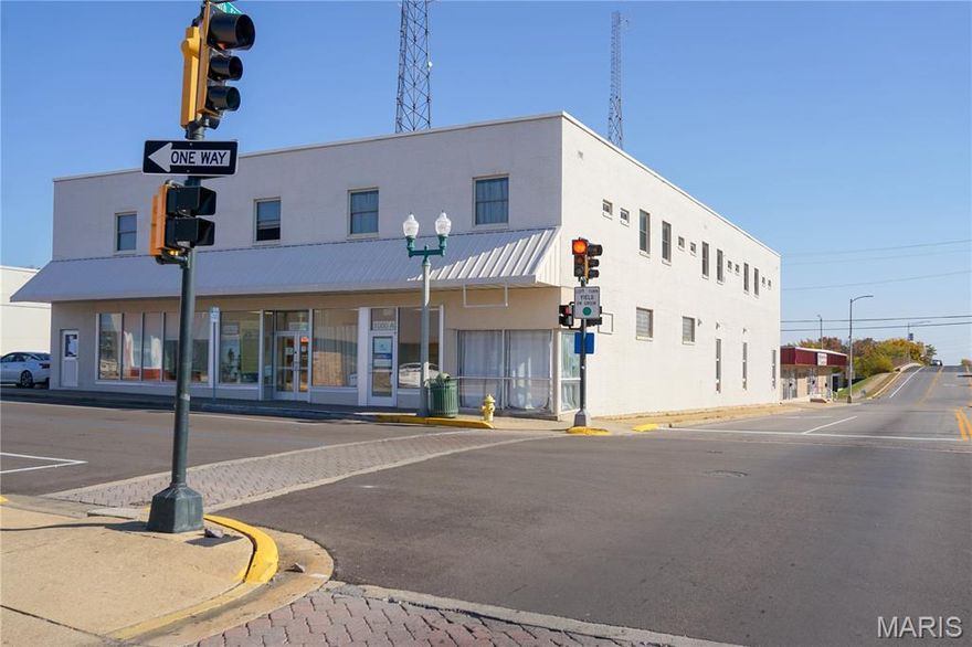 This 18,386 +/- sq. ft. mixed-use property sits on a corner lot at N. Pine Street and W. 10th Street, offering excellent visibility and accessibility. Located within walking distance of Missouri S&T, this property includes a combination of office space and furnished residential units.

The upper level features 16 furnished units with private baths, a shared kitchen, and on-site coin-operated laundry. The main level includes two professional office suites and 8 additional furnished living units. Each unit is furnished with a full-size bed and mattress pad, dresser, desk with chair and lamp, microwave, and a full-size refrigerator/freezer. The community area includes a full kitchen with seating and a comfortable lounge space.

Suite A offers approximately 1,200 sq. ft. with a reception area, three offices, a conference room with kitchenette, and a private bath with shower. Suite B provides approximately 2,200 sq. ft. with a reception area, nine offices, a conference room, kitchen area, and two bathrooms.

The property also includes asphalt parking with 16 spaces and a side parking garage. Great occupancy and steady income make this an excellent investment opportunity in a desirable Rolla location near downtown and Missouri S&T.