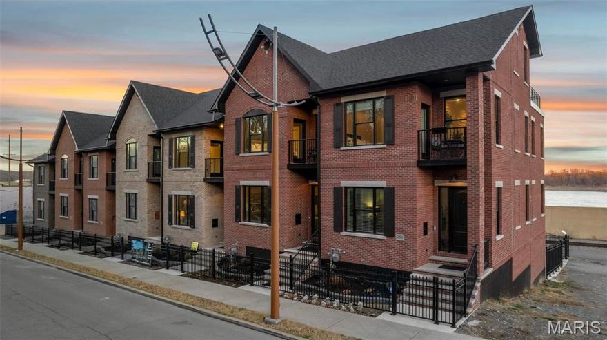 Welcome to the River's Edge Townhomes - where luxurious finishes are shared with modern conveniences. Featuring free panoramic views of the Mississippi River from every level, this 4 story townhome features a private elevator, green space for those little pets, high end appliances, 2 kitchens, and 4 decks, with one deck being on the roof-top level with a kitchenette and private bath for guests. You'll find mostly wood floors throughout, high ceilings, custom moldings, and not a detail missed throughout.  The master suite features a private deck, separate jacuzzi/shower, spacious walk in closet and wood floors.  Come take a peek at this nearly finished townhome!  Same floor plan as our model home, but completely different decor and finishes inside.