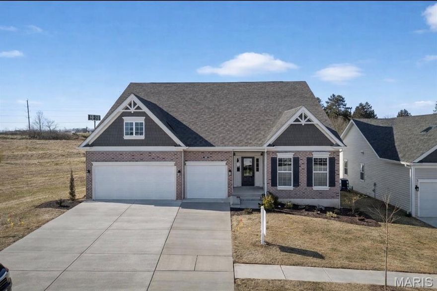 Welcome to the impressive Braxton 1.5-story home in the highly sought-after Cedarstone community of Dardenne Prairie. Offering over 3,546 sq. ft. of beautifully designed living space, this home combines elegance, functionality, and modern comfort. The open floor plan highlights a dramatic two-story great room with a gas fireplace, abundant recessed lighting, and wiring and bracing for future ceiling fans — creating a bright and inviting atmosphere ideal for both entertaining and everyday living. The kitchen showcases custom two-tone cabinetry with crown molding, soft-close dovetail drawers, hardware, and stunning quartz countertops, pendant lighting, a large island, and stainless-steel appliances. The main-floor primary suite serves as a private retreat, offering spacious comfort and stylish finishes. Upstairs features generously sized secondary bedrooms, a large bonus room, and additional fan bracing throughout for added convenience. Outside, enjoy the 16x14 patio — ideal for outdoor gatherings — along with a 3-car garage for plenty of parking and storage. Situated on a beautiful homesite within the award-winning Wentzville School District, this home offers easy access to shopping, dining, and recreation. Experience the perfect balance of quality construction, thoughtful design, and timeless style at Cedarstone — where luxury living meets everyday practicality.