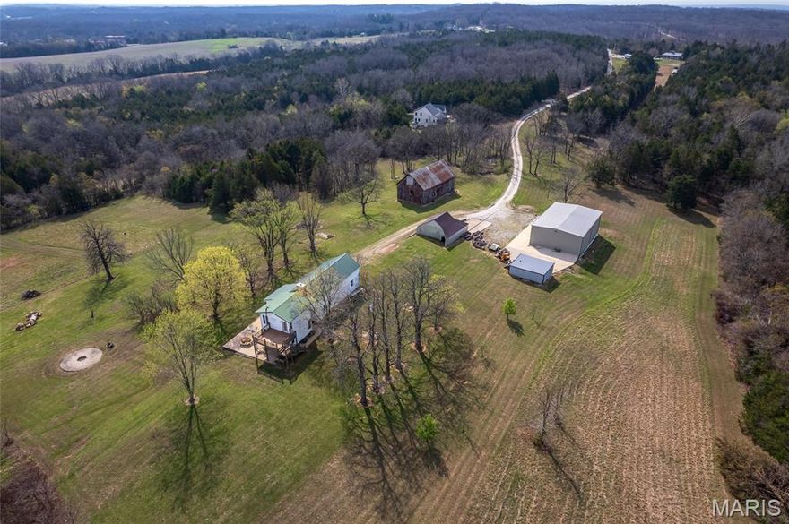 Well, here's your chance!!!  54 acres just west of Union on Hwy 50!!  These don't come up often!!  Original log home was built in 1847 and has had some renovation work.  Addition to the home was done in 2000 and is beautiful!!  A kitchen to fall in love with, breakfast nook, 2 bathrooms and a bedroom.  Living room has original exposed logs, nice fireplace and hardwood floors!!  Outside you'll find a charming,  old red barn, equipment shed and a 60 x 40 outbuilding with overhead door, concrete floor, heat, electric and another bathroom!!  Beautiful acreage and a location perfect for full time living or a weekend place!  Off the beaten path yet not far from the beaten path....