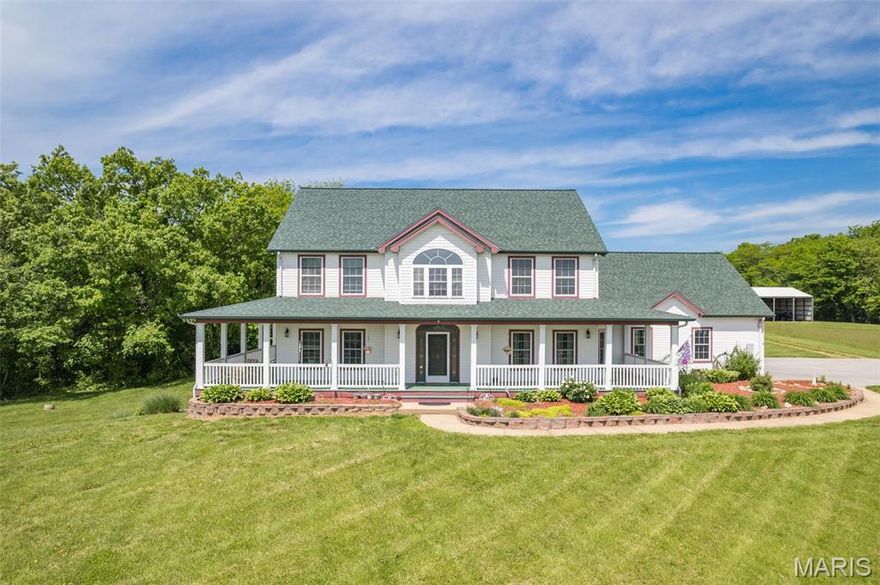 Price Improvement! Custom 1.5-story home on 52+ picturesque acres, just 30 mins from St. Louis County. Quality craftsmanship throughout. A 2-story foyer opens to a dining room and great room with floor-to-ceiling windows and a striking stone wood-burning fireplace. The chef’s kitchen offers a large island w/ cooktop, built-in oven, ample cabinetry & high-end stainless appliances. Breakfast room features bay window & patio access. Main-floor primary suite boasts a spa-like bath, walk-in closet & wraparound porch access. Upstairs: loft + 3 beds w/ private baths. Finished lower level w/ family room, bonus room & full bath. Property includes 42x60 barn w/ water, tack room, 6 stalls (1 birthing), 42x50 outbuilding, 16x16 outbuilding w/ electric, arena w/ lights, trails & 25+/- acres pasture. RV hookups: 30 amp at garage, 50 amp at barn. Active horse community w/ 3 show venues within 10 miles. Bed & breakfast potential!