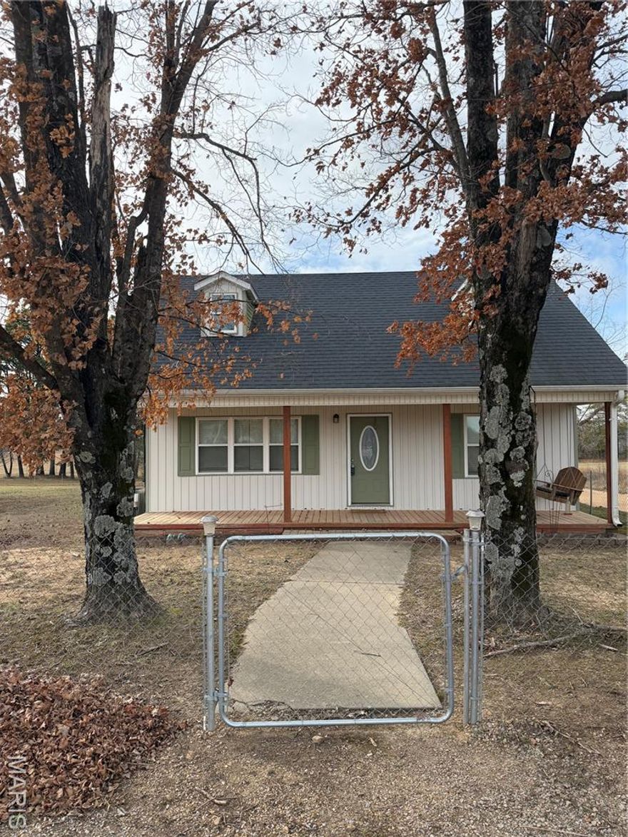Welcome to this exceptional country ranch–style residence situated on a spacious corner lot, offering privacy, functionality, and timeless charm. This well-appointed home features four generously sized bedrooms and three full bathrooms, thoughtfully designed for comfortable everyday living and entertaining.

The interior showcases custom stone accents, including a stunning stone kitchen island and elegant stone pillars framing the dining area, creating a warm and refined focal point. The primary suite offers a private retreat complete with a tiled walk-in shower. Newer carpet and updated flooring throughout enhance the home’s modern appeal while maintaining its rustic character.

Additionally, there is a loft located above the two-car garage, ideal for additional storage space or could be converted into additional living quarters. Outdoors, enjoy a fully fenced, private yard with a wood deck, perfect for relaxing or hosting gatherings. The property also includes an approximately 15' x 25' concrete shed equipped with a 30-amp RV hookup, along with a private well and two septic systems, providing efficiency and convenience.

This property offers the perfect balance of space, quality features, and peaceful surroundings—an excellent opportunity for those seeking refined country living with modern comforts.