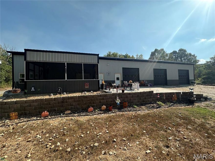 5,000 sq ft building just outside city limits.  Concrete floors heated.  Parcel #'s 16-503-21-00-023.00-0000 & 16-503.21-00-023.01-0000  Endless possibilities.  Great for business or home & shop.  4 overhead doors.  Duplicate listing to MLS #25064543.