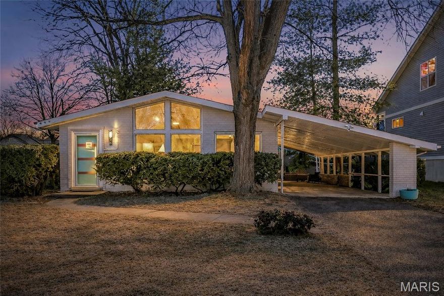 Showings begin Wed. 3/4! Dreamy 1956 mid-century modern tucked into a fantastic Rock Hill neighborhood in the Webster Groves School District. This one captures everything we love about California-inspired MCM design — clerestory windows flooding the home with natural light, vaulted ceilings, warm hardwood floors, and an easy, open floor plan that just feels good.

The kitchen is completely brand new and thoughtfully done: 42” custom cabinetry, stainless steel appliances (refrigerator, gas range, built-in microwave, dishwasher), double sink, garbage disposal, under-cabinet and recessed lighting, plus luxury vinyl tile flooring. And the best part? The retro tile was preserved for just the right pop of vintage personality.

The primary bedroom features its own updated en-suite half bath, keeping the cool, well-preserved tile that MCM lovers appreciate. The full hall bath follows suit — refreshed, yet honoring the era.

A rare find for this style, the finished walkout lower level offers incredible extra living space. You’ll love the vintage solid wood paneling in the family room, complete with a custom bar and brand-new LVT flooring. There’s also an office/sleeping room, a full bath, and generous unfinished storage with a workbench and utility sink.

Outside, enjoy the long two-car tandem carport and a patio overlooking the perfectly sized, mostly fenced backyard.

The sellers have truly loved living here — in part because of the neighborhood itself. Walk to Hudson Elementary and Oakhaven Park with tennis courts, super fun playground, and walking trails. It’s the kind of community that’s hard to leave!