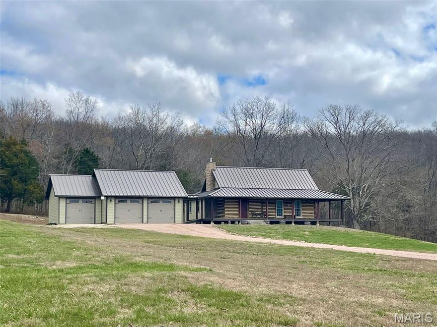 Historic Charm Meets Modern Comfort on 9.56 Acres:
Step back in time without sacrificing today's conveniences! This stunning 160+ year old log home, once a schoolhouse, was carefully taken down and beautifully rebuilt in 2016-preserving its rich history while incorporating modern upgrades throughout.
Nestled on 9.56 acres just minutes from Fredericktown, MO, this one-of-a-kind property offers privacy at the end of a dead-end county-maintained road with breathtaking views from the inviting wraparound porch.
Inside, the home features 2 bedroom and 3 full baths, with 1,544 sq ft on the main level and 2,697 sq ft of total living space. The main floor includes a spacious primary suite with a walk-in closet, granite countertops in the kitchen, stainless steel appliances, and a cozy living room anchored by a wood-burning stove capable of heating the home.
The full walk-out basement expands your living and entertaining space with a large family room, beautiful hand-built bar, gas fireplace, 2 sleeping rooms and another full bath. This added space is perfect for guest, extended family, or entertaining!
Additional features include a 3-car detached garage with breezeway, peaceful country sitting, swimming pool, hot tub, great hunting, and the convenience of being just minutes from town.
This rare blend of history, acreage, and modern comfort doesn't come along often, schedule your private showing today!