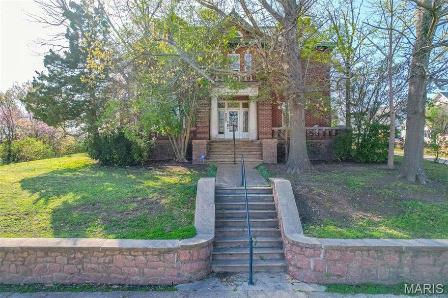 Built in 1917, the Corrigan House is a distinguished Neocolonial-style home listed on the National Register of Historic Places since 1998. Situated on a gently sloping lawn. The front of the property is framed by an original pink granite and concrete retaining wall. The stately exterior showcases a stretcher bond brick entrance with limestone Tuscan columns, a Spanish clay tile roof, and expansive covered porches and balconies. The backyard has an in-ground pool, hot tub, fencing, and a carriage house with covered parking. Inside, this home is filled with architectural details that reflect its rich history. Hardwood floors extend throughout, with tile flooring in the kitchen and bathrooms. The entrance features stained glass windows, which are also found in the dining room and the second floor. Two elegant parlors, spacious rooms, and a formal dining area create a warm and inviting atmosphere. Additional features include a finished attic space and a basement, offering ample storage.