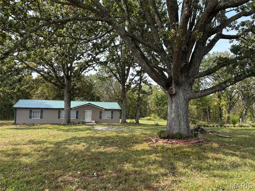 Tucked away in a private, secluded setting, this well-maintained 2004 double wide offers peaceful country living on 11.5 mostly wooded, fully fenced acres—perfect for hunting or enjoying abundant wildlife. The home features 2x6 walls for added durability and efficiency and sits on a solid 60x30 concrete pad with a circle drive for easy access. Recent updates include a new metal roof with gutters and leaf guard installed in 2023, along with a 300-foot well featuring a new pump and 36-gallon pressure tank installed in 2022. Outside, you’ll find four water faucets for added convenience. This move-in ready property combines comfort, privacy, and practicality, making it an ideal retreat or full-time residence.