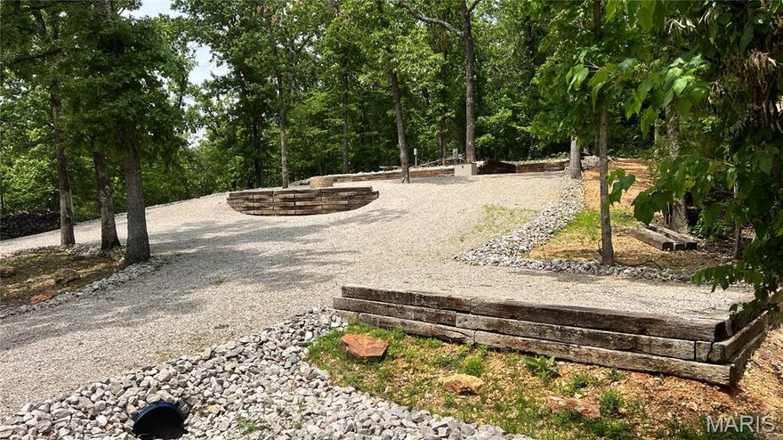 Who’s ready to make unforgettable memories this summer? 
I've got the perfect getaway waiting for you!  Located inside the gated Lake Perry Community, this beautiful spot at Lot 1036 Erie Trail Drive (0.73 ac) offers stunning lake views. This fully set-up, camp with permit lot makes it easy to enjoy lake life from day one.  Whether you are out on the lake relaxing in the water or back at the lot soaking in the peaceful surroundings at your fire pit, this is the ideal place to unwind.  Enjoy breathtaking sunrises and sunsets right from your lot, making every moment feel like a vacation. There is space available for a shed or pavilion with electric ran to either one on top of the hill and electric ran also for boat cover.  The camper electric service hook up is 50 amp. and there is access to hook onto Lake Perry sewer system if you would choose. As part of the Lake Perry Community, you'll also have access to amazing amenities including:  swimming pool, recreation center, laundromat & showers, sandy beaches, pavilions, and playgrounds.  All amenities are within a secure, gated community designed for comfort and fun.  Don't miss your chance to own the perfect summer escape.  Reach out today to schedule a viewing and start making lifelong memories at your new favorite spot!
