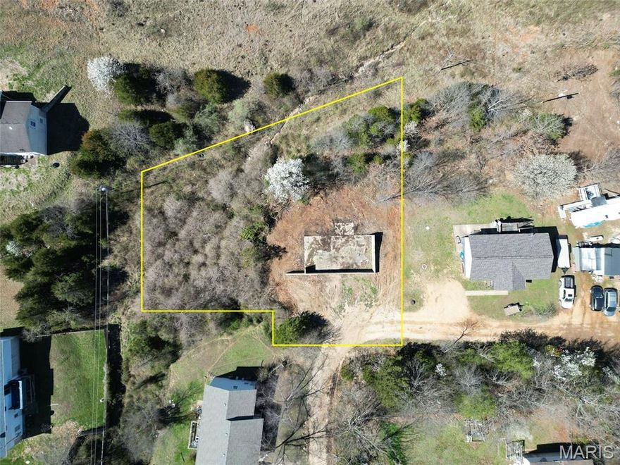 Investors take notice! This .48 acre property located in the Waynesville School District offers a great opportunity with an existing foundation already on site. Public water and sewer are available nearby, making this a promising location for a future build or investment project. Buyer to perform their own due diligence regarding utilities, zoning, and development possibilities. Note: Aerial view and boundary lines are approximate and are provided for reference only. They should not be used in place of a professional survey.