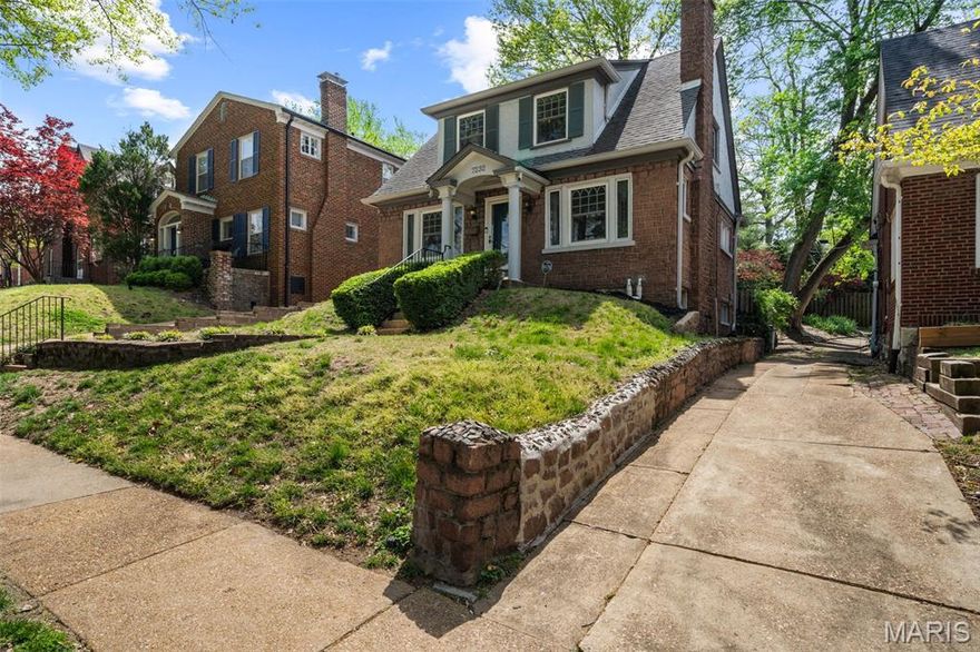 Charming Tudor-inspired brick home showcasing timeless architectural details and thoughtful updates, ideally located just moments from Washington University and the shops, dining, and conveniences of downtown Clayton. From the moment you step inside, the home’s character is on full display. The inviting living room features beautiful stained glass windows and a wood-burning fireplace nestled between built-in bookcases, creating a warm and distinctive focal point. The main level offers a functional and well-balanced layout with a formal dining room, updated kitchen, and a rear family room that provides additional living space. The kitchen blends style and practicality with stainless steel appliances, granite countertops, and a glass tile backsplash. A conveniently located half bath on the main floor features a glass-tiled accent wall, adding a modern touch to the home’s classic feel. Upstairs, you’ll find two comfortable bedrooms along with a versatile bonus room—perfect for a home office, guest space, or nursery. The full bathroom has been updated to complement the home’s overall aesthetic. The lower level provides excellent storage and includes a 1-car tuck-under garage. Heating is provided by functional radiators, paired with central air conditioning for year-round comfort. Step outside to enjoy a sizeable, fully fenced backyard complete with a concrete patio—ideal for relaxing, entertaining, or enjoying the outdoors. With its blend of original character, modern updates, and an unbeatable location, this home offers a unique opportunity in a highly sought-after area.