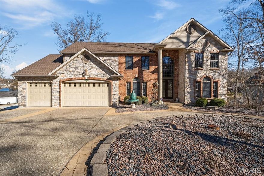 Wake up to water views and wind down with sunsets—this executive, stone-facade lake home delivers the lifestyle you’ve been waiting for. Set on the waterfront in a gated community, it offers 5 beds and 4.5 baths designed for both everyday living and unforgettable entertaining. Open kitchen/family room flow to a sunroom w/ French doors opening to the deck and lake. Covered dock invites morning coffee, paddle time, or evening gatherings. Inside, enjoy a library, formal dining room, gas fireplaces, & private office w/deck access. Retreat to Primary Suite with a second-floor deck overlooking the water, spa bath, and expansive walk-in closet. Upstairs includes a Jack-and-Jill suite, additional bedroom & hall bath. Lower level shines w/ full bar, full kitchen, rec room, game area, fifth bedroom, hot tub & bath—perfect for hosting. Circle drive, 3-car garage, north-facing backyard for summer shade, & quick access to the gate. Cue the soundtrack—don’t stop believin’-lake life done right. Home is located close to entrance gate for easy in and out. Agent owned.