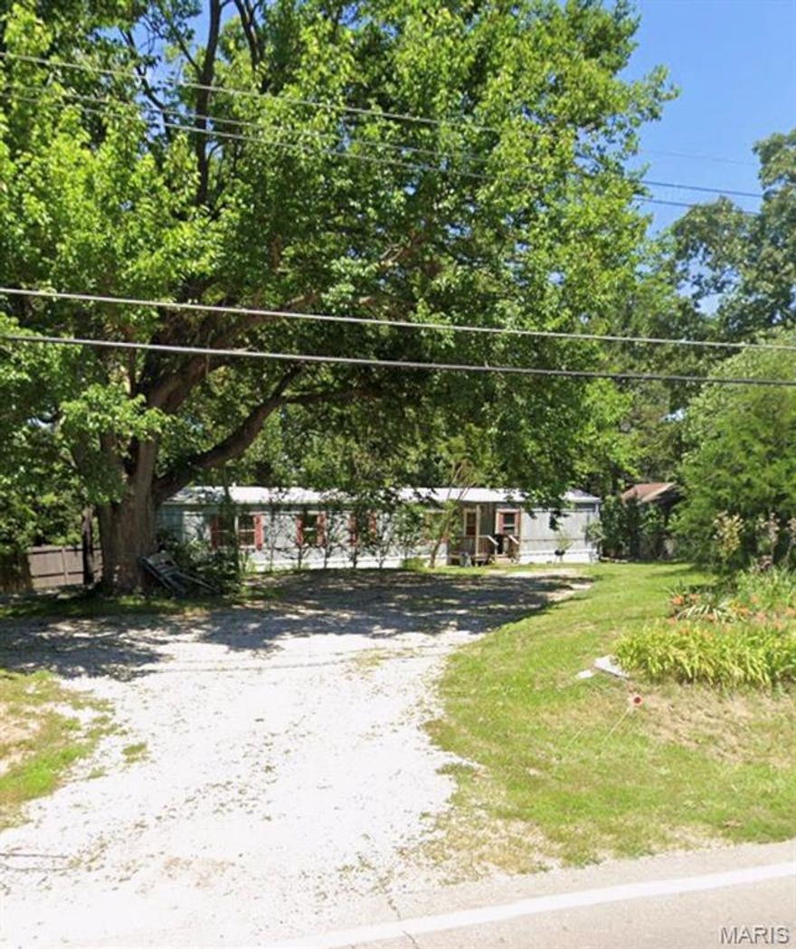 Located in the sought after Jefferson R-7 School District, this unique property offers exceptional versatility and opportunity. Featuring a circle drive plus additional space for a second driveway, the layout provides excellent access and functionality. The property includes two ideal building sites, making it well-suited for future new construction or expansion. Utilities are already in place with an existing septic system and public water, adding convenience and value. A 3-bedroom, 2-bath manufactured home, affixed and built in 1986, is currently situated on the property. The land boasts dual road frontage, with access from Highway TT and additional frontage along Burley Road, offering strong visibility and accessibility. The property has no restrictions outside of Jefferson County, MO building codes. The property is being sold AS-IS and is broker-owned in the state of Missouri.