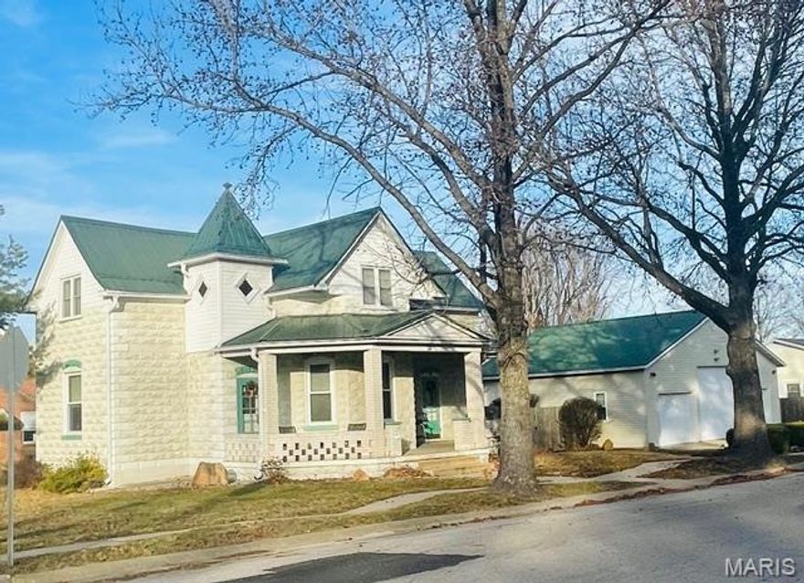 This beauty has it all...beautiful wooden pocket doors, cased with original wide baseboards, tall ceilings, wrap around front porch with brick columns and railing.  Plenty of kitchen cabinets, all kitchen appliances are included, newer high efficiency natural gas furnace, also an electric f/a furnace.  This spacious living room boasts tall ceilings with period millwork.  Detached 3 car garage with concrete floor, electric, and lots of storage.  The oversized door that will store a camper, and an attached workshop area in the back of the garage.  Wooden privacy fence installed in 2021.  Leaf guards installed on home and garage with transferrable  lifetime warranty.  All this sits on 3 1/2 level lots.   New Whirlpool dishwasher January 2026-