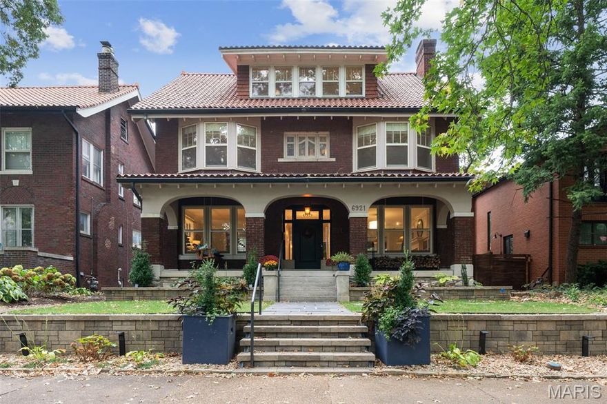 Circa 1920, this exceptional Ames Place residence blends timeless architecture with modern comfort in one of University City’s most coveted neighborhoods. Just three blocks from Washington University, Forest Park, and the Loop—and only minutes from downtown Clayton—this home offers a lifestyle defined by convenience, charm, and sophistication.

The classic front porch and handsome tile roof set the stage for a warm welcome. Inside, a gracious center hall leads to spacious rooms filled with natural light, hardwood floors, and exquisite architectural details. Stained glass windows, custom built-ins, and an impressive fireplace anchor the living spaces, while a sun-filled sitting room frames views of the gardens. The updated kitchen is a true centerpiece, appointed with granite counters, abundant cabinetry, and luxury appliances designed for both everyday living and entertaining.

The second floor offers four well-sized bedrooms, a Jack and Jill bath, a second full bath, and a delightful porch off one of the bedrooms. This level provides the flexibility for family, guests, or work-from-home needs and even allows for an alternate primary suite. The third-floor primary is a private retreat, featuring two walk-in closets, a spa-inspired bath with soaking tub, separate shower, dual sinks, and the convenience of an in-suite laundry.

The lower level expands living space with a large screening room, dog wash, and half bath—perfect for movie nights, hobbies, and practical everyday use. Energy-efficient upgrades include new custom storm windows, a tankless hot water heater, and zoned heating and cooling, ensuring year-round comfort with modern efficiency.

Outdoors, the home invites relaxation and entertaining with a spacious screened porch, flagstone patio, and professionally designed gardens that provide both beauty and privacy. A two-car garage and rebuilt cobblestone pad add practicality, accommodating up to four vehicles with ease.

Blending historic character, thoughtful updates, and modern amenities, this Ames Place home offers the rare opportunity to enjoy classic architecture alongside today’s luxuries—all in a location that is second to none. Neighborhood indentures and additional information about Ames Place can be found at amesplace.org