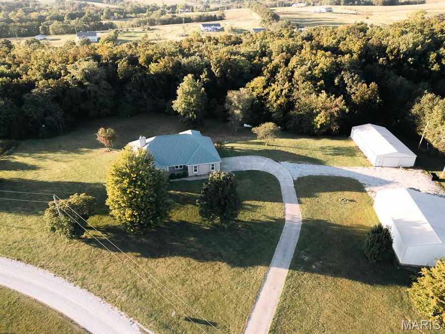 If country living is what you've been looking for... clear your schedule to look at this total package! This beautiful atrium ranch is nestled on 10.98 Ac m/l in northern Lincoln County & features a short drive to Hwy 61 on the edge of smalltown USA. This one-owner, custom home features over 3400+ SF and includes 3 bedrooms, 3.5 baths. The main floor offers a great room with beautiful brick fireplace (high-efficiency) & vaulted ceiling with a beautiful wall of windows overlooking your private back yard and tons of wildlife! The floor plan is an open concept with kitchen, dining room, great room, breakfast area, and hearth room. The hearth room also features beautiful oak floors and a 2nd fireplace while also overlooking the covered deck! If you REALY like to entertain - you have a 2nd full kitchen in the finished lower level with large dining area, game room, & family room w/ a 3rd fireplace (wood burning)! In addition, there still remains lots of unfinished area for in-house storage! Need more storage? This property also features 2 HUGE outbuildings - 30x50 w/ 14' lean-to & 30x60 w/ concrete floor and electric in both! You can finally cancel your current storage fees & bring your hobbies, collections, boats, and campers! This property is ready for you today and there's likely room for it all! More information is coming soon with professional photos of this beautiful country estate!