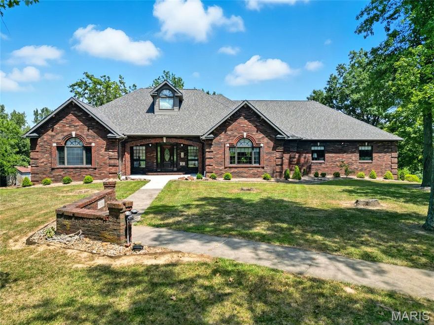 Discover unmatched craftsmanship & comfort in this custom full-brick ranch, offering over 6,000 sq ft of total living space surrounded by 5 serene acres (10 additional acres negotiable). Main level offers 10-ft ceilings–some vaulted, Pella windows, solid-core decorative wood with transoms, custom red oak cabinetry & built in bookcases/shelving (all reclaimed from a historic high school chemistry lab), pantry, main floor laundry, spacious dining area, breakfast room & 8-person breakfast bar. Features 4 BRs (4th w/o closet, armoires stay), 3 full baths, plus add’l lower-level bathroom & laundry rough-in. With potential for two kitchens, making it ideal for multi-generational living. Main-level gas fireplace & lower-level wood-burning fireplace/furnace for added heat source. Oversized, tandem 4-car garage - heated/cooled/220 electric. 4 HVAC units - new high-efficiency gas furnace (2023) & geothermal, 800-ft well (new pump 2021), central vac, attic fan, hot tub-ready hookup, stocked shared pond & circle drive. Home is furnished with many historic items, and some may stay if buyer chooses. There is so much more, too numerous to mention - additional details available upon request. This beautiful home is in a peaceful rural setting close to both Chester IL & Perryville MO, that blends luxury finishes, energy efficiency and country living—offering an ideal retreat for families, hobbyists, or those seeking an expansive forever home.