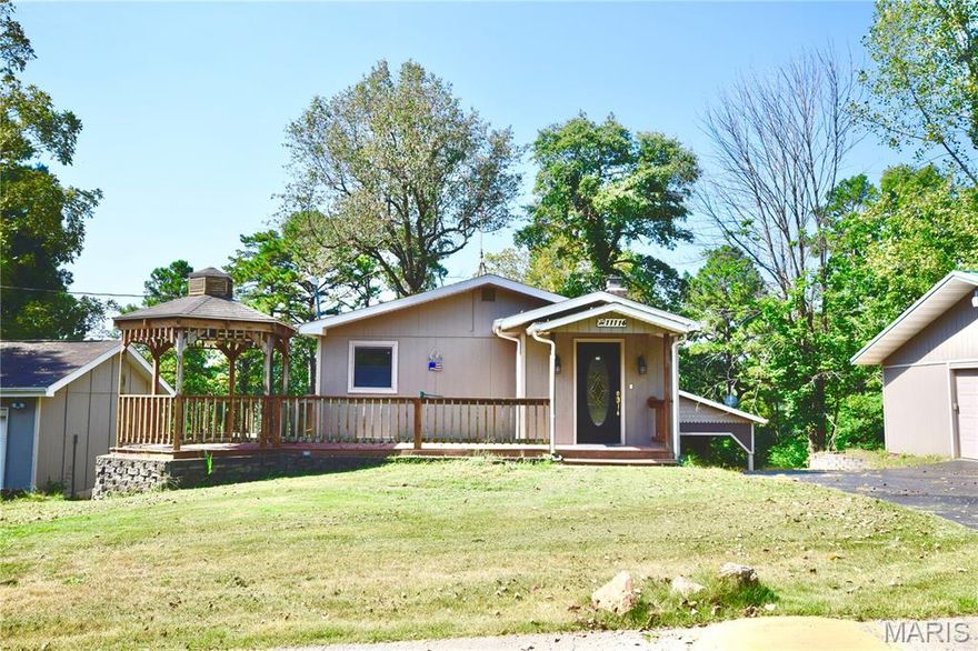 Sitting on FOUR LOTS in the private Grayhawk community, this 3 bed, 2 bath home is the perfect year-round spot or weekend escape! The updated kitchen has granite counters and a center island plus the dining area features a cozy wood-burning fireplace. Enjoy a living room AND a sunny four-season sunroom with beautiful, wooded views that leads to a flat side yard and a covered patio. There are TWO detached garages (32x32 and a 24x30 - both have concrete floors and electric!), plus RV parking with electric and water on its own lot. You'll really enjoy the covered patio/party area too! The septic system was replaced with a NEW system just a few years ago and the house is in great condition! BUY WITH CONFIDENCE! The sought after Grayhawk subdivision offers nearly 1,000 acres with 200 acres of stocked lakes for swimming, fishing, boating, and hiking, and it’s just minutes from historic Ste. Genevieve.