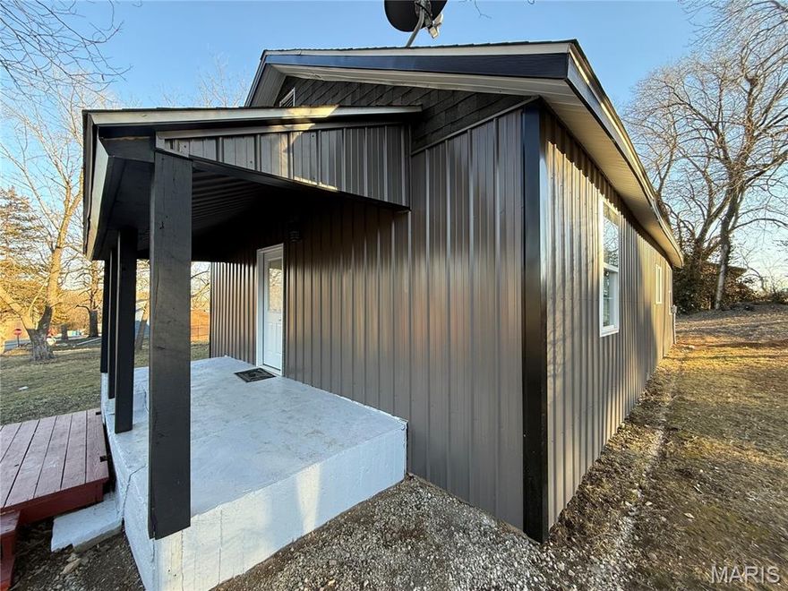 Updated Barn Style Home on Corner Lot! New siding. Updated paint, sheet rock and flooring. Hight Ceilings, almost 10'. Nice and tall! New kitchen with refrigerator, stove. 2 primary bedrooms with full baths. One with a laundry room ofl the kitchen/dining room. Central heat and air. Large back deck. Covered front porch. West Plains School District. Parking Pad. Double lot. Will qualify for any type of government financing