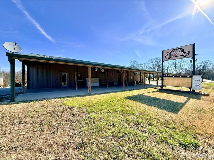 Opportunity awaits with this well-known commercial property formerly known as “The Spillway,” located just outside the gates of the Lake Perry community. Perfectly positioned to serve the steady flow of campers, boaters, and lake visitors, this versatile property offers a rare chance to step into a ready-to-operate business just in time for the busy lake season. The building features two established business components. One side operates as a convenience store with gas pumps, making it an ideal stop for fuel, snacks, supplies, and essentials for those heading to and from the lake. The other side functions as a bar and grill, offering a welcoming space for dining, drinks, and gathering after a day on the water. Both areas come fully equipped with the necessary equipment, allowing a new owner to simply stock product and begin serving customers almost immediately. Built in 2005 with an addition completed in 2007, the property includes a large covered front porch—a favorite spot for customers to relax, dine, and socialize in a laid-back lake atmosphere. The commercial property sits on 3.09 acres, providing ample space for parking and future possibilities. Adding even more value, the sale also includes a 1.54-acre Lake Perry access lot. This additional property features a 20x50 covered carport with an attached porch and storage area, along with water, sewer, and electric already in place, making it ready for immediate use. This business has long been a staple for the lake community, and nearby residents and lake visitors alike have been eager to see it reopen. With its prime location, established reputation, and turnkey setup, this property offers an exciting opportunity for the next owner to bring new life to a beloved local destination.