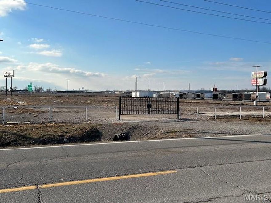 Prime 2.6-acre property with all city utilities and services readily available.  The gravelled, fenced lot with highway sign availability provides the perfect foundation for different types of operations.