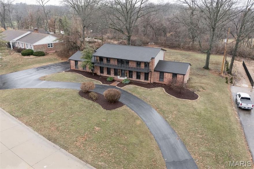 Situated on a1-acre estate lot within a coveted lake and park community, this newly renovated full-brick residence offers over 4,800+ finished square feet of exceptional design, craftsmanship, and generational versatility. Timeless original millwork blends seamlessly with custom architectural details, creating warmth and sophistication throughout. The gourmet kitchen is a true showpiece, appointed with high-end appliances, quartz countertops, custom cabinetry, designer tile backsplash, statement range hood, and a striking custom butler’s arch—crafted for both elevated entertaining and refined everyday living. Designed for flexibility, the home features dual primary suites on the main and upper levels, ideal for multigenerational living or private guest accommodations. The main-floor primary suite is complete with a private sitting area, full-wall closet, and en-suite bath. Upstairs, a second primary suite provides a true retreat with private balcony access plus a dedicated dressing room with closet space for effortless organization. Two additional upper-level bedrooms also feature balcony access, enhancing architectural interest and natural light. The finished lower level expands the living experience with a wet bar, half bath, expansive recreation room, and abundant storage. Exterior features include a stately brick porch and walkway, a sweeping circle drive, oversized two-car garage with built-in storage closets, and a distinctive half-moon patio with garden walkway—perfect for intimate evenings or larger gatherings. Three fireplaces—including a gas focal point and two original surround electric-ready add architectural character and ambiance. A full-home electrical rewire ensures modern reliability behind its timeless aesthetic. With exclusive resident access to a private lake and park, this property delivers not simply upscale square footage—but lifestyle, legacy, and enduring value.