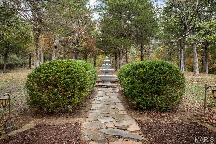 A Very Rare Opportunity — Nearly 14 Acres of Private Living
This extraordinary property offers the perfect blend of privacy, old world charm, elegance and endless potential. From the moment you arrive, the well-lit drive, tranquil fountains, and picturesque landscape set the tone for your true private sanctuary.
Walk into a dramatic two-story foyer and large open staircase, complemented by custom millwork, rich hardwood floors. Light and bright...this home features a large number of Palladian windows and bay windows that frame breathtaking views of the surrounding landscape. The open-concept kitchen and hearth room are designed for both everyday living and entertaining, featuring solid-surface countertops, a breakfast bar, a butler’s pantry, large center island and premium built-in Sub-Zero refrigerator, dishwasher, trash compactor and more. Hearth room features large stone fireplace and both rooms welcome you to step outside to the expansive, beautiful, low-maintenance deck and take in peaceful overlook views—an ideal space for morning coffee or evening gatherings. The primary suite is a true retreat, offering an extra-large bedroom, a spa-like bath with double vanities, a separate shower and soaking tub with a wonderful view, and a generous walk-in closet.

The finished lower level expands the living space with a large family room (also suitable as an additional bedroom), a full bath, large game room, and wet bar, all opening to a private, covered patio—perfect for indoor-outdoor entertaining. Basement also has and additional washer/dryer hook-up. 

Car enthusiasts and hobbyists will appreciate garage parking for five vehicles. Just steps away, a barn-style building with finished second-level space provides exceptional flexibility—ideal for conversion to a barndominium, office, studio, or hobby space... building also has an additional lean-to for outdoor equipment or 6th car...building is not included in the home’s square footage and offers endless possibilities. 

Solid property was completely Union built and also features 2 x 6 exterior walls plus electric has already been run to the property line for future electric gate installation (controlled by switch at front door). 
Move right in or update to your personal taste—either way, opportunities like this are seldom available. Privacy, views, acreage, and unmatched versatility come together in one remarkable estate.