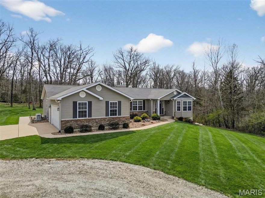 Experience the perfect blend of space, privacy, and convenience with this beautiful home on 8.49 acres in Wentzville. Tucked just minutes from Hwy 70 and 61, this property offers the rare opportunity to enjoy peaceful acreage living without sacrificing accessibility. This open floor plan split bedroom home features approximately 1,800 square feet, vaulted ceilings, 3 bedrooms and 2 full baths, along with a spacious oversized 2 car drywalled garage, taped and painted. Large Primary Bedroom boasts a private entrance w/Atrium Door. Kitchen is equipped with LG Black Stainless Steel Appliance suite (2022), and gorgeous Brazilian Cherry Hardwood Floors. The great room boasts a Lenox Ladera EPA Certified Wood Burning Fireplace-finished in Dry Stack Stone. Oversized laundry area doubles as a functional drop zone, offering added storage for everyday convenience. Unfinished walkout basement ready for your vision—ideal for additional bedrooms, recreation space, or multi-generational living adding long-term value. Step outside and enjoy your own private retreat with a composite deck and patio ideal for entertaining, relaxing, or taking in the surrounding nature. 800’ Asphalt Driveway with Privacy of an Electric Security Gate, Montavue HD 4K  Pan/Tilt/Zoom Security Camera System, Dimensional Security Home Alarm System, Police and Fire Department Monitored, Sundance Payton 6 Person Spa on Concrete Patio with Sidewalk (2021), 24’ x 16’ All Composite Deck with Sawmill Wood Pergola Gazebo & 100-Year-Old Tin Roof. Generac 22KW Propane Whole House Generator, Personally Owned 500 Gallon Ferrellgas Propane Tank, 500-gallon Fresh Water Storage Tank in Basement. Professionally Power Washed; House, Deck, & Concrete plus Concrete sealed (2026). Elevated (10’) Hunting Blind at Back Property Line. The acreage provides endless possibilities, whether you’re looking for space to expand, add outbuildings, or simply enjoy the open land. Properties offering this much land, location, and livability are hard to find—schedule your showing today.