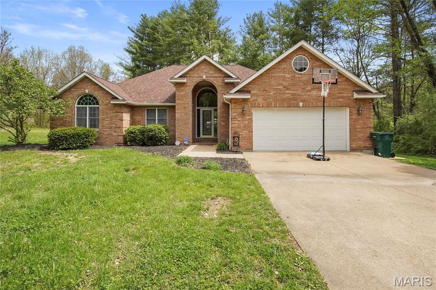 Enjoy peaceful living just moments from the golf course in this spacious 3-bedroom, 2-bathroom home in The Pines Subdivision in Rolla! Situated on a generous .96-acre lot m/l, this property offers approximately 2,025 sq ft of comfortable living space surrounded by mature trees and a serene setting. Step inside to an open living area featuring tall ceilings and a cozy fireplace—perfect for relaxing or entertaining. The spacious kitchen is designed with functionality in mind, offering an island, breakfast bar seating, and ample cabinetry for storage. The breakfast room and separate dining room offer great entertainment spaces. The large primary suite provides a private retreat with a double vanity, jetted tub, and separate shower. A covered front entry with soaring ceilings creates a welcoming first impression, while the back deck overlooks the private backyard—ideal for enjoying the outdoors. Complete with a 2-car attached garage, this home combines space, comfort, and a desirable location near the golf course. Schedule your private tour today!