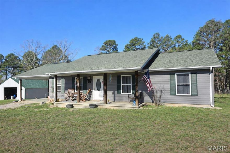 Beautifully set on 10 acres of scenic countryside, this 3 bedroom, 2 bath home offers privacy, space and a peaceful setting. The spacious living area providers a comfortable gathering space, while the kitchen features ample storage and workspace ideal for everyday living and entertaining. Primary suite, recessed lighting, six panel interior doors and attached carport. Enjoy peaceful mornings and evenings on the covered front porch overlooking a stocked pond with large mouth bass, perch and catfish. Property is already set up and ready to go for a small hobby farm with steel pipe and woven wire fencing, 5 hydrates and pasture. A 26x36 pole barn, two chain link dog kennels and small loafing shed. Located only a few minutes from Boiling Springs Resort on the Big Piney River!