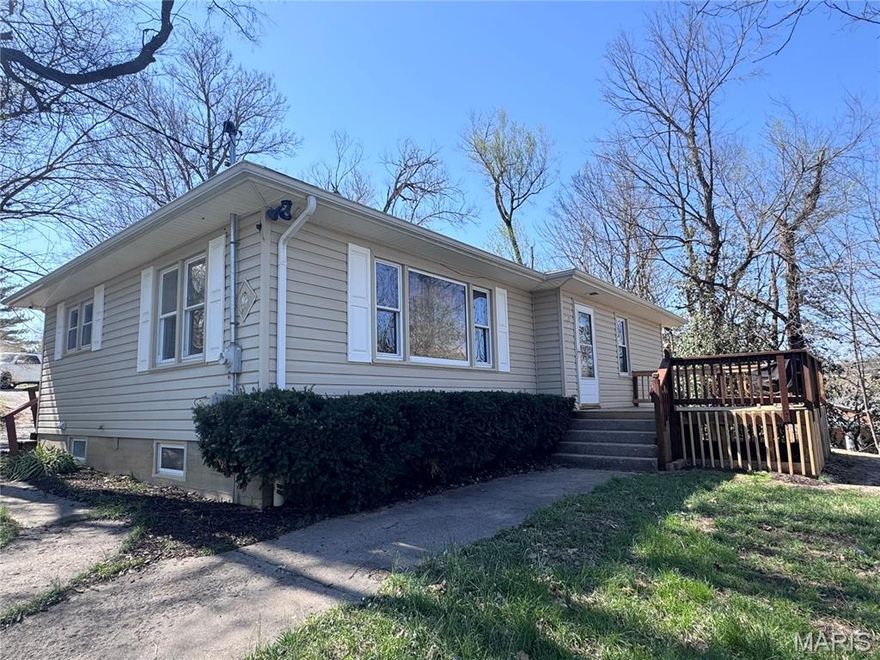 Located near Historical Downtown Hannibal you will find this 1950's bungalow set on a wooded lot with both front and back decks! The flow of the home is accented by the beautiful wood floors and arched doorways typical of the 1950's design. Your main level offers a spacious living room, eat-in kitchen and 3 bedrooms plus the main bath. Need a place to hide away? The basement offers that perfect get-a-way! Massive family room PLUS the laundry and full bath! Schedule your showing today!!