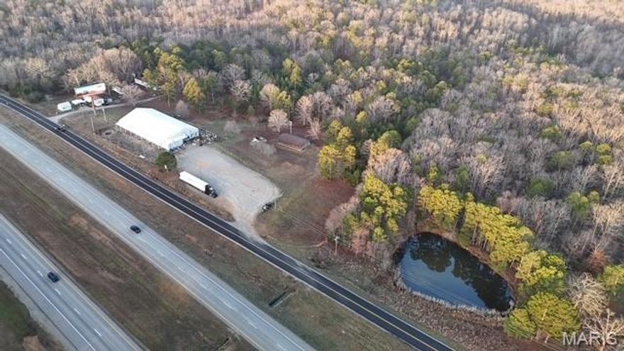 Prime commercial opportunity on High-Traffic location! Positioned just north of Poplar Bluff on approx. 5 acres +/- being offered, this property is over 8,000 sq ft +/- of space with endless potential for business, industrial, or investment use. The building features 12-foot ceilings, a 20x24 office space, two bathrooms, and an alarm system-making it well-equipped for warehouse operations, distribution, storage, or commercial ventures. Outside, the property expands its income potential with 15 storage units located along the side of the building, plus 7 mobile home pads that provide additional revenue opportunities. A billboard currently generates $1,400 per year in rental income, adding yet another income system.
With excellent visibility in a high traffic-area, ample space for expansion, large parking, and additional acreage available for negotiation, this property offers incredible flexibility for investors or business owners looking to grow.
