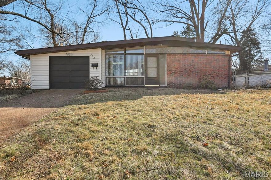 Located in Ferguson-Florissant Schools, this 2-bedroom, 1-bath ranch offers 1,484 sq ft of main-level living on a 0.19-acre lot. Built in 1956, this slab home features two separate living areas plus a bonus room ideal for a home office, flex space, or playroom. The living room includes large front-facing picture windows and a white-painted brick wood-burning fireplace. A separate family room  provides additional gathering space and includes a wood-burning stove. Laminate plank flooring runs through the main living areas, and neutral interior paint creates a consistent, updated feel. The kitchen features white cabinetry, stainless steel range and microwave, dishwasher, tile backsplash, recessed lighting, and ample counter space. The adjacent dining room offers dedicated space for meals separate from the main living areas. Both bedrooms are positioned on the main level along with a full bath featuring an updated vanity and tub/shower combo with tile surround. A dedicated laundry room adds functional storage and utility space beyond a typical closet configuration. Exterior features include a brick and siding façade, covered entry, one-car attached garage, mature trees, and a fully fenced side yard. The lot measures approximately 0.19 acres. System updates include water heater (2019) and HVAC (2022). The home also offers
Nearby amenities include Koch Park (4 mi), Florissant Golf Club (4 mi), Sunset Park (5 mi), St. Ferdinand Park (2.4 mi), Florissant Valley Branch Library (2 mi), Schnucks grocery (1.5 mi), and access to I-270 (2.7 mi).
Includes 3D walkthrough and floor plan viewer for layout reference.