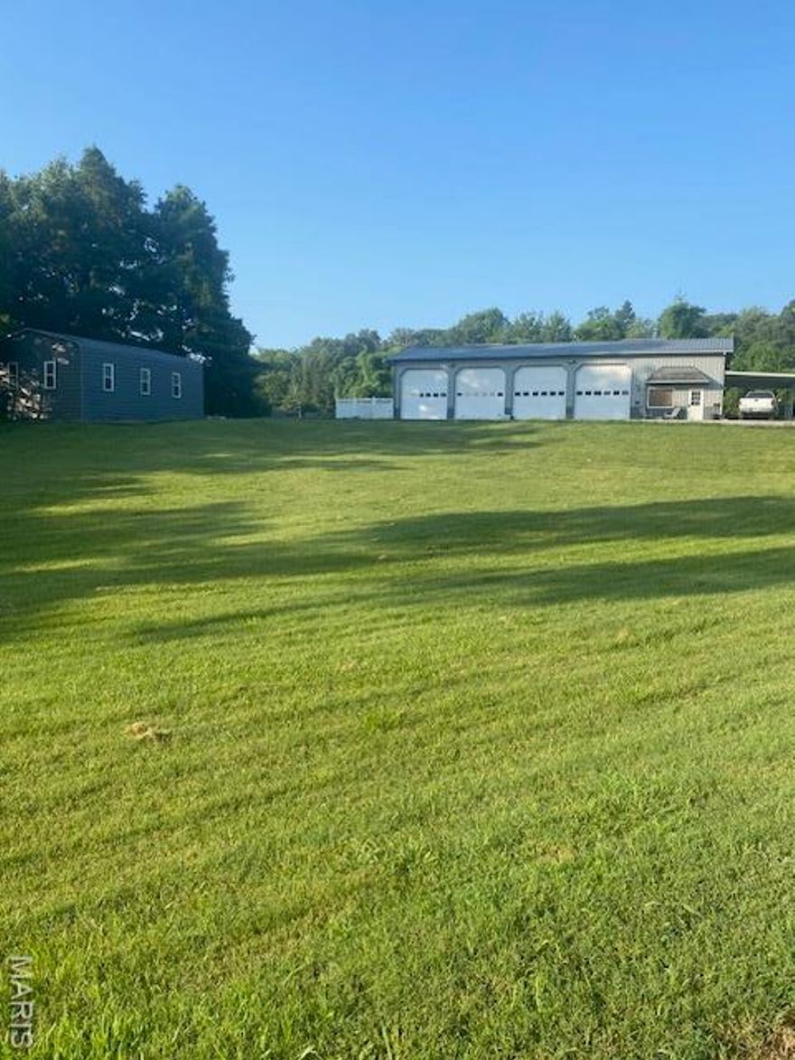 Great Location for Commercial business convenient to Cape and Jackson! Sitting on 3.3 acres is a '32x72' shop building with a 12'x 16' finished office area, '6x9.5' bath, four '12x12' overhead doors, and a '16x33' attached covered carport. Also includes a rear '16x72'storage/shop area with two overhead doors. In addition there is a spacious '24x36x13' carport/storage area. Comes with security system. Great for commercial or residential growth, making this an ideal location for investment or business expansion. The seller is a Missouri licensed real estate agent