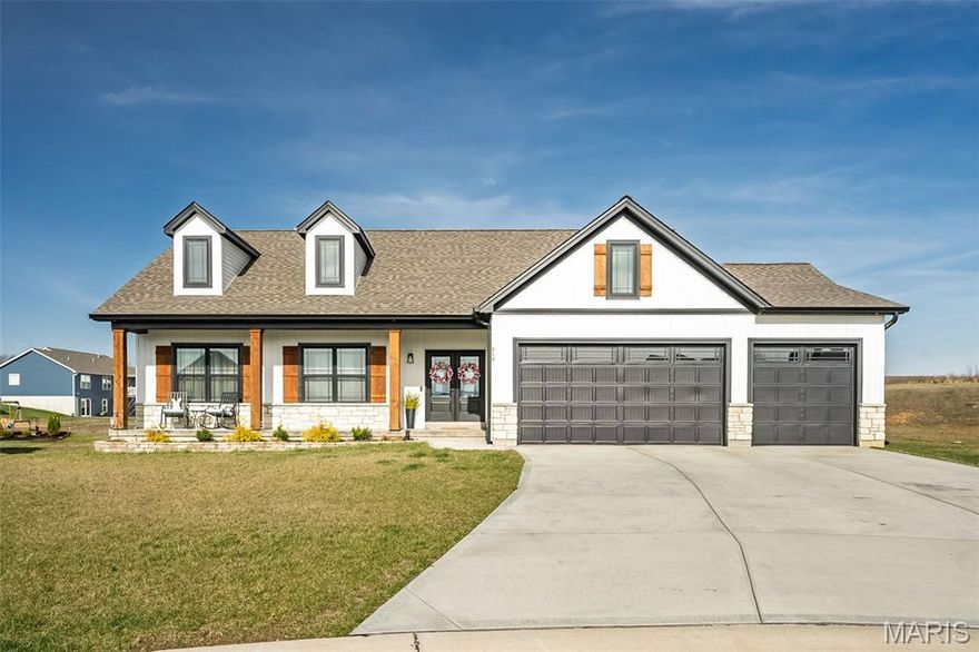 Why wait to build when this beauty is move in ready, beautifully maintained, and full of upgrades? This modern farmhouse stunner is located on one of the largest and more private lots in the subdivision, a full acre! From the moment you arrive, you'll appreciate the curb appeal, with an inviting front porch, board and batten siding, solid cedar posts and shutters, and double front doors with black decorative grid - matching the windows. 
Inside, from the large entryway, your eyes are immediately drawn to the custom fireplace wall and upgraded lighting everywhere. This home offers a warm and functional layout with tons of builder upgrades like canned lighting in the soffits, an extended garage, rod and spindle staircase, and ceiling fans. 
The finished basement is a true highlight and an entertainers paradise - featuring an extra bedroom, a stylish bar area, a "hobby" room with a pegboard wall,  and a spacious recreation area! The full bath is framed out and ready to be finished.