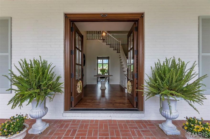 Experience timeless elegance at 323 White Oaks Lane, a French-inspired luxury home in one of Cape Girardeau’s most prestigious neighborhoods. Spanning over 5,000 sq ft, this exquisite home blends timeless design, modern sophistication, and exceptional craftsmanship. The main-floor primary suite offers a custom walk-in closet by Mike Buessink—complete with luxury cabinetry and Gucci wallpaper—and a spa-like bath with heated tile floors, dual-tiled shower, and MCI soaking tub. The chef’s kitchen features custom cabinetry, deVol hardware, and an 8-burner Ilve stove with double oven. Mahogany doors, hickory floors, and brass switchplates by Forbes & Lomax add rich character throughout. Outside, enjoy a private oasis with a heated saltwater pool on 2.41 secluded acres. Welcome to a home where elegance, comfort, and timeless beauty meet.